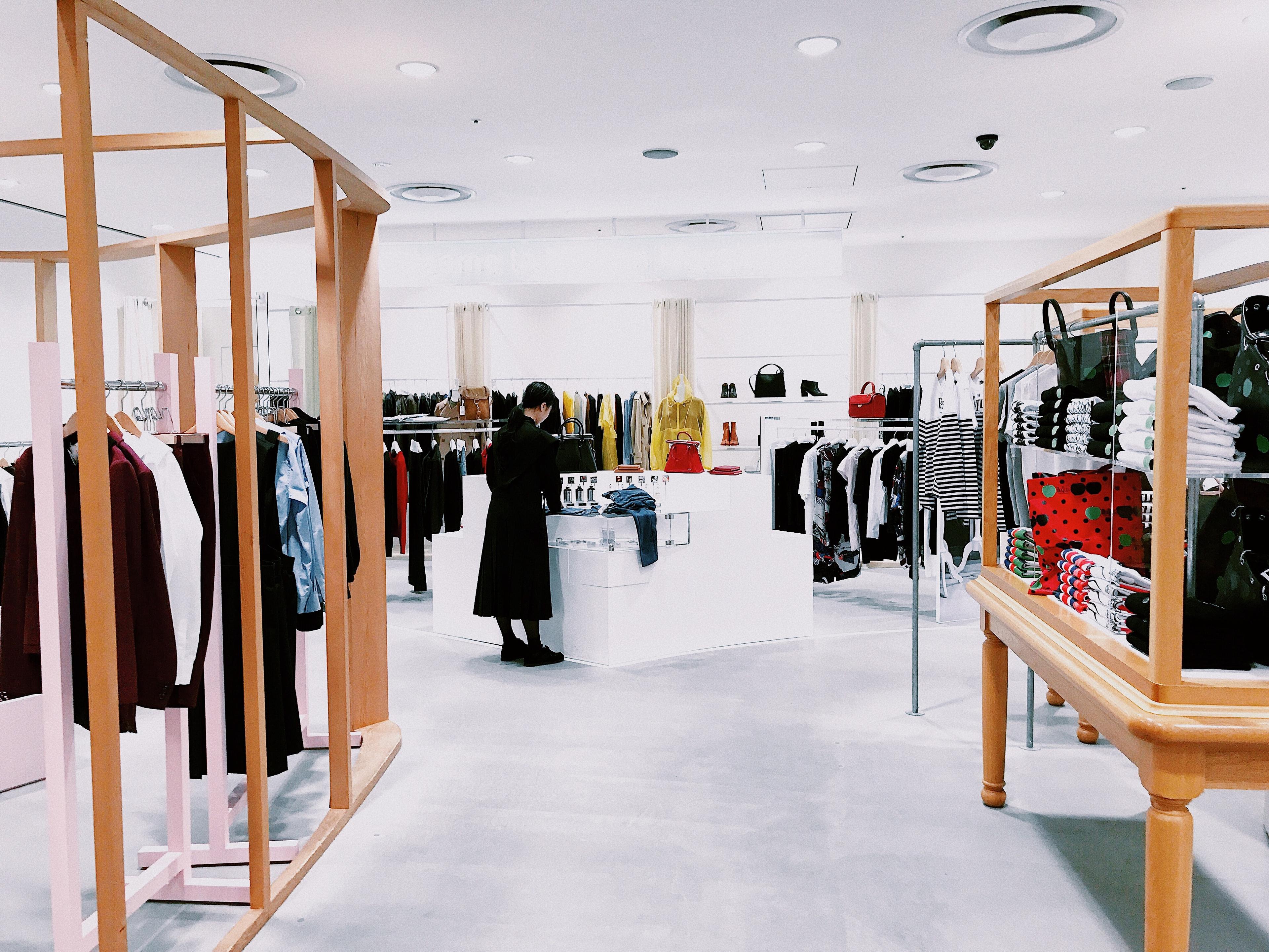 A woman browsing a clean-looking fashion store