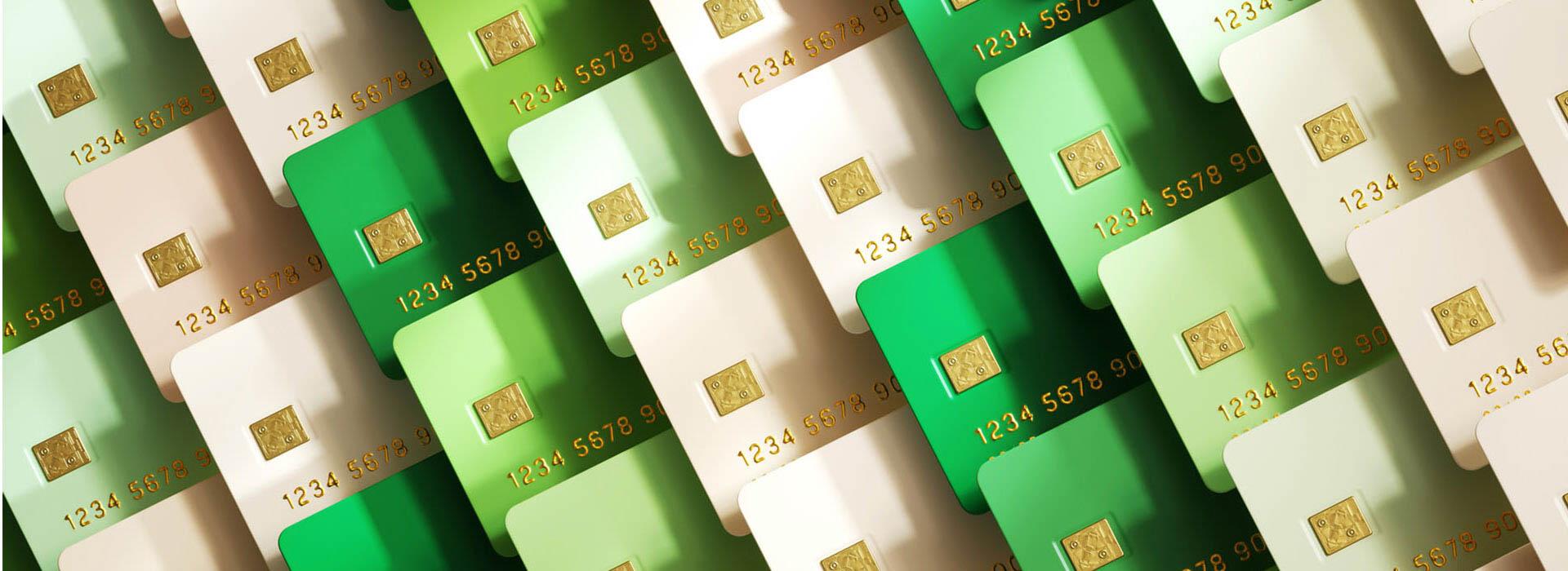 variety of credit cards in a variety of green shades overlapping each other