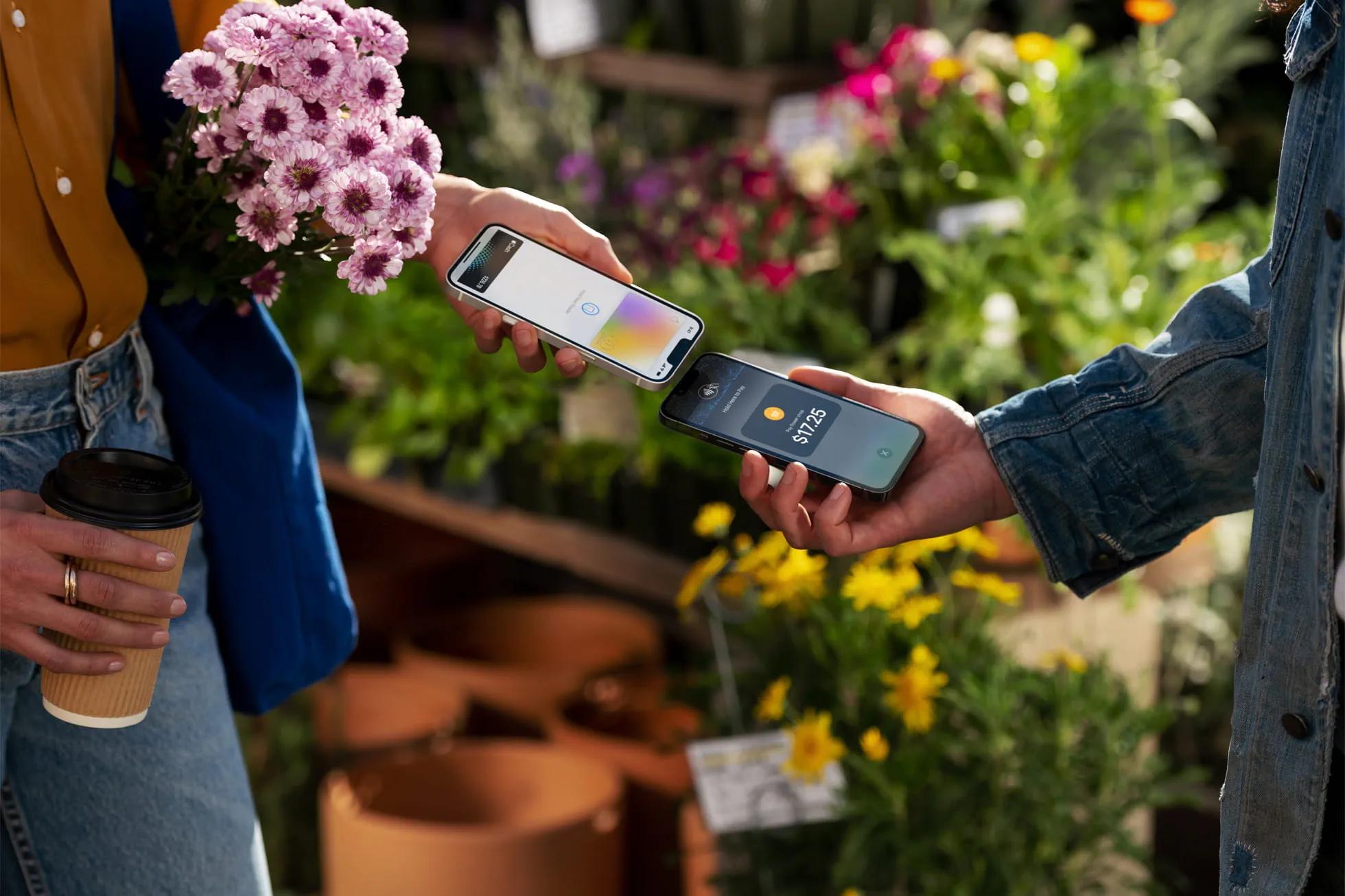Paying at a flower shop using tap to pay on iphone with two phones